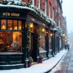 globe boss dublin services (2) Snow falling on a charming, festive British street with a pub.