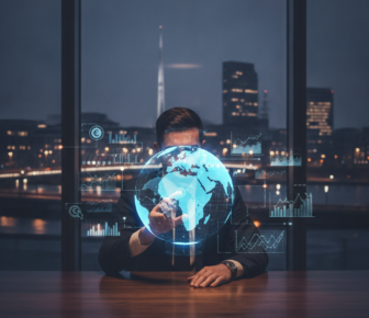 Businessman holding holographic globe with digital marketing analytics