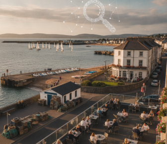 Coastal town harbour terrace dining with sailboats at sunset