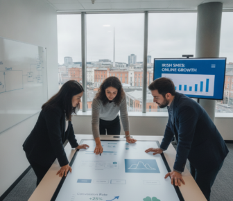 Three professionals reviewing Irish SME growth data on touchscreen table