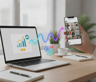 Hand holding social media phone beside laptop analytics dashboard